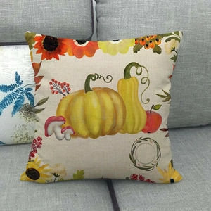 Macro detail of linen pillowcase with watercolor autumn pumpkin and sunflower prints