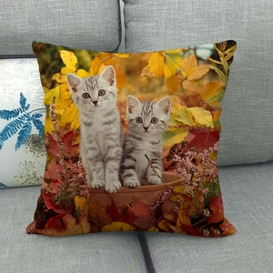 Detail of linen pillowcase featuring digital print of kittens among autumn maple leaves