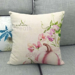 Close-up of linen pillowcase with pink pumpkin pattern and autumn breath text