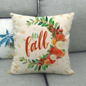 Fall pumpkin wreath linen throw pillow cover with Let's Fall lettering on gray sofa