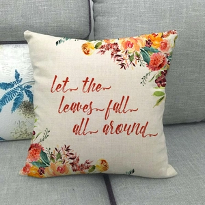 Close-up of linen pillowcase with autumn floral patterns and orange pumpkin theme