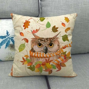 Detailed close-up of autumn owl linen pillowcase on a grey sofa showing fabric texture