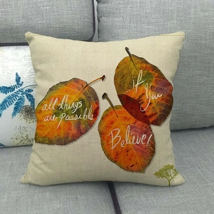 Detail of linen Thanksgiving pillow cover featuring fall leaves and motivational quotes