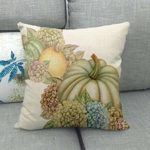 Detailed texture of linen pillowcase featuring watercolor green pumpkin and floral patterns