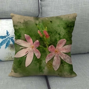 Close-up of pink floral linen pillowcase showing textured fabric on a gray sofa