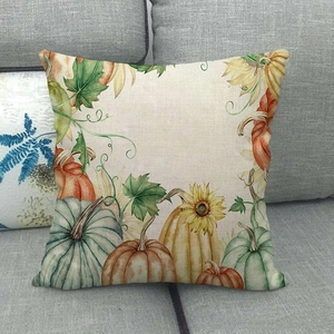 Autumn watercolor pumpkin and sunflower linen pillowcase on a grey fabric sofa