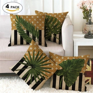 Detail of four linen pillow covers featuring green tropical leaves and yellow dot patterns