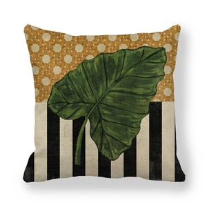 Detailed texture of linen pillowcase with green tropical leaf and geometric stripes