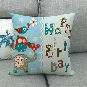 Cartoon owl elephant linen pillowcase with Happy Birthday text on grey sofa