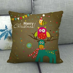 Close-up of linen pillowcase featuring cartoon owl and reindeer Christmas patterns