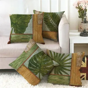 Close-up of tropical green leaves and seashell patterns on four linen pillow covers