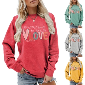 Close-up of 'Let all that you do be done in LOVE' print on cotton blend women sweatshirt
