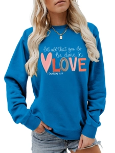 Close-up of blue crewneck sweatshirt featuring white typography print on the chest