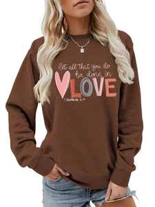 Detail of white LOVE print and biblical verse on dark brown crewneck sweatshirt