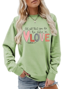 Detailed view of sage green long sleeve sweatshirt with ribbed crew neck and text print