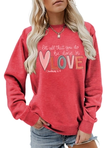 Close-up of ribbed cuffs and high-quality red fleece fabric on women's crewneck sweatshirt