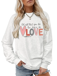 Close-up of heart print and inspirational text on grey crewneck sweatshirt fabric