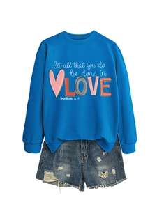 Detail of royal blue sweatshirt with 'Let all that you do be done in love' print
