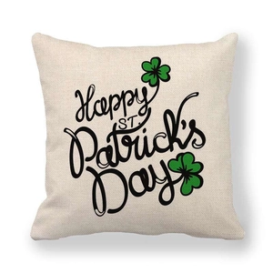 Detail of linen St. Patrick's Day pillowcase with green shamrock and festive text