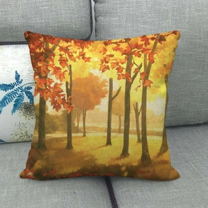 Detail of linen pillowcase with autumn forest landscape on a grey fabric sofa