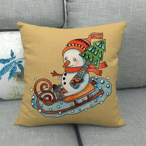 Mustard yellow linen pillow cover featuring a snowman skiing with a festive winter print