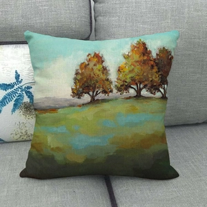 Linen throw pillow cover featuring oil painting style autumn landscape on a gray sofa