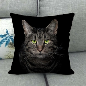 Detailed close-up of a realistic tabby cat face print on a black linen pillowcase