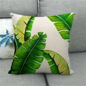 Close-up of tropical banana leaf print on textured linen fabric throw pillow cover