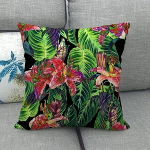 Detailed texture of linen cushion cover with pink lilies and green leaves on grey sofa