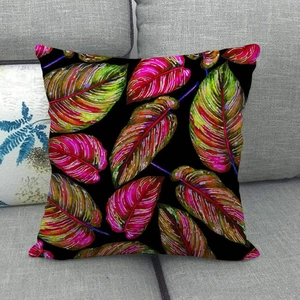 Macro detail of tropical leaf patterns on black linen throw pillow case on gray sofa