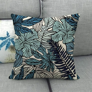 Close-up of tropical blue floral pattern and linen texture on square pillow cover