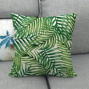 Green palm leaf pattern linen pillow cover on a gray sofa for home decoration