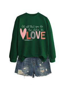 Detail of dark green sweatshirt with Let All That You Do Be Done In Love text art
