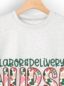 Detail of grey crewneck sweatshirt featuring Labor & Delivery floral nursing print
