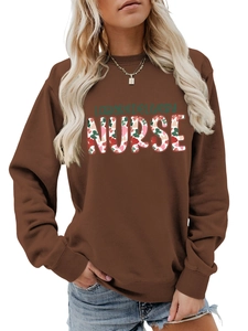 Detailed close-up of floral nurse lettering on a comfortable brown crewneck sweatshirt