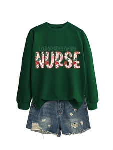 Flat lay of a green Labor & Delivery Nurse sweatshirt with distressed denim shorts