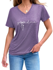 Close-up of purple V-neck T-shirt featuring white grandma lettering and a bow print