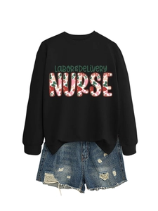 Detail of black nurse sweatshirt with floral typography and frayed denim shorts set