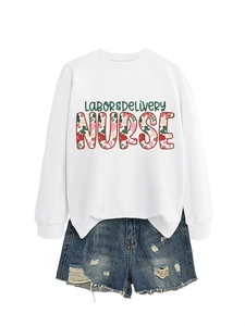 Detail of white Labor and Delivery Nurse sweatshirt with floral typography and denim shorts