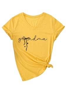 Close-up of yellow V-neck T-shirt with grandma text print and stylish side knot detail