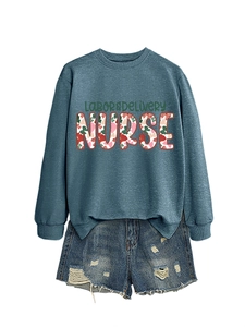 Detail view of Labor & Delivery Nurse sweatshirt with floral texture and denim shorts