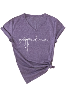 Close-up of purple V-neck t-shirt featuring grandma script and white bow graphic detail