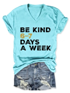 Detail of Be Kind letter print on V-neck short sleeve tee and distressed denim shorts