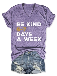 Detail of V-neck purple T-shirt with Be Kind print and distressed denim shorts set