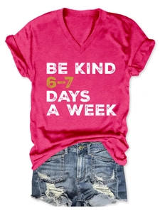 Close-up of V-neck T-shirt with Be Kind slogan and distressed denim shorts set