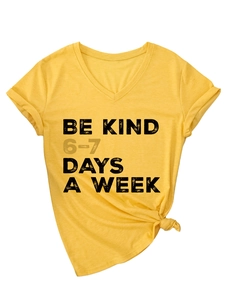 Detail of V-neck cotton T-shirt featuring side-tie knot and BE KIND printed slogan