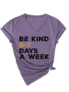Detail of purple V-neck T-shirt showing folded sleeves and BE KIND graphic slogan