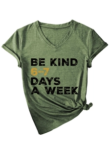 Detail of army green V-neck T-shirt with Be Kind slogan and trendy side-knot styling