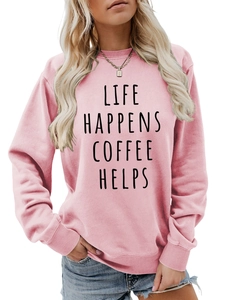 Detail of pink crewneck sweatshirt with 'LIFE HAPPENS COFFEE HELPS' slogan text