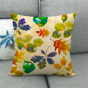 Detailed texture of linen pillowcase with colorful autumn maple leaf patterns on sofa